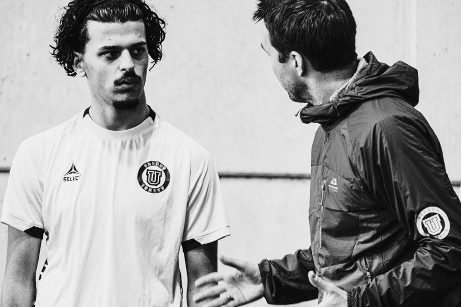 a man with his hand on another man's shoulder